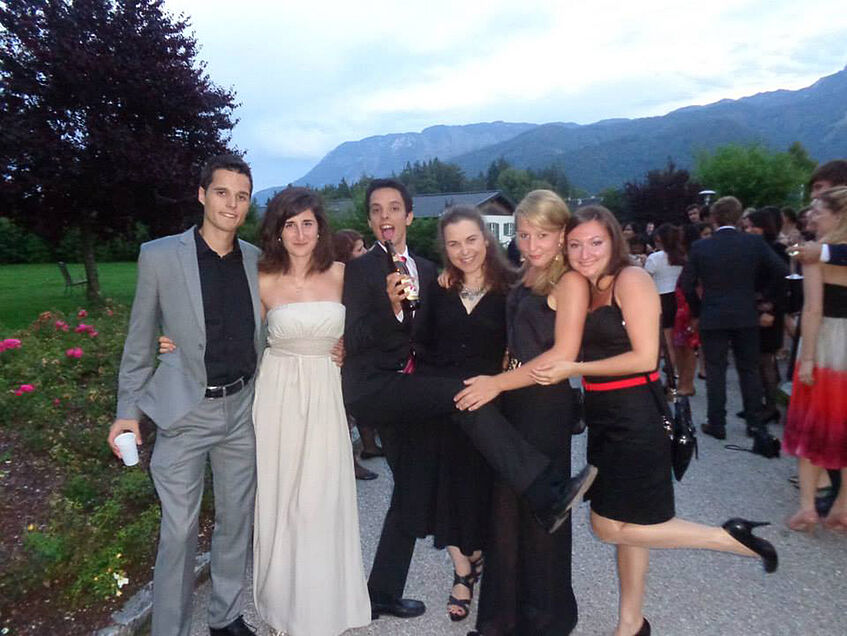 This picture was captured during the midsummer night's ball 2014.</p>
<p>From left to right: Petar Brudar, Krystallenia Paniskaki, Nicolás Cabrera, Aleksandra Gjorgieska, Looes Herdersche, and Varvara Aleksić.</p>
<p>I would also like to stress out the mountains that can be seen in the background. I have still the picture of them in front of my eyes, because I remember with how great desire I watched them during the German classes – dismal while I could not go outside. However, from this distance I see how important those German classes were. They actually were the best German classes I have ever participated in and they improved my German extremely. Those mountains thus, stand as a symbol of motivation in my mind. (© Peter Brudar)