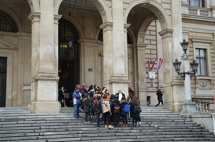 Participants gathering on the steps of teh front entrance of the University of Vienna